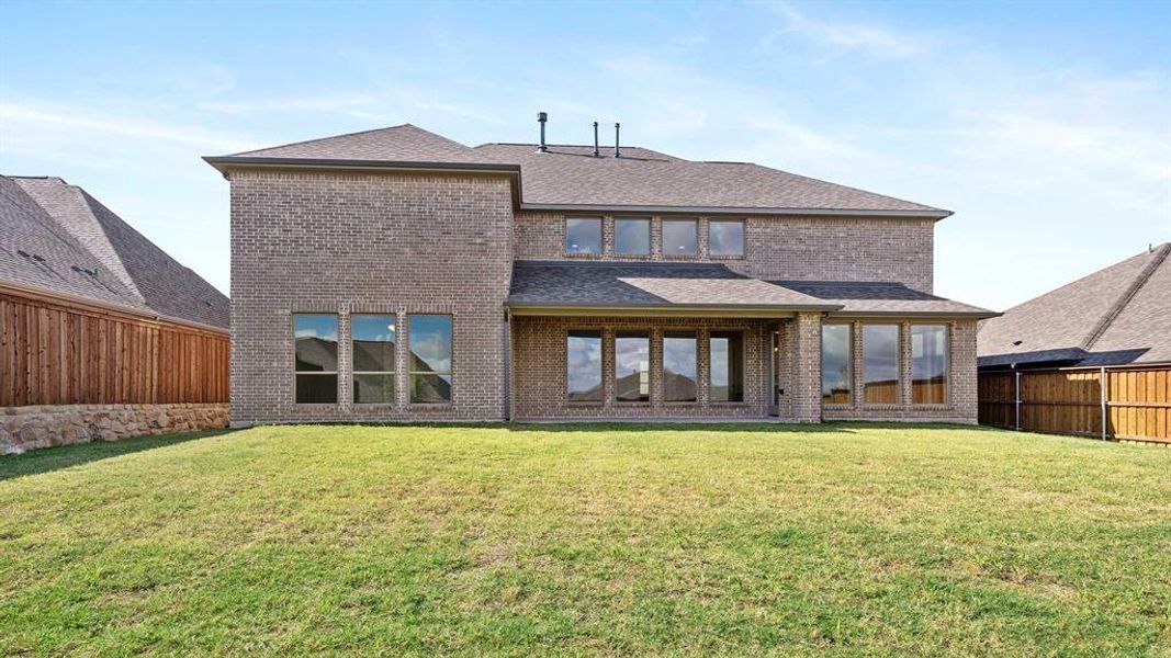 Rear view of property featuring a yard