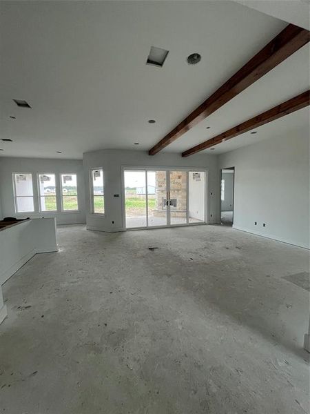 Great Room with stained beams and 12-foot sliders to back patio.