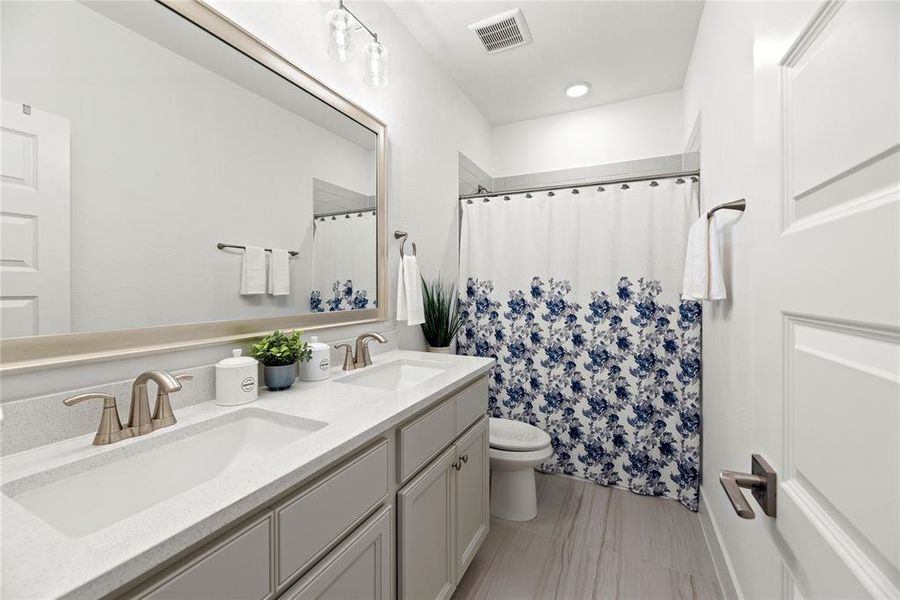 Secondary Bath with Dual Sinks perfect for Guests.