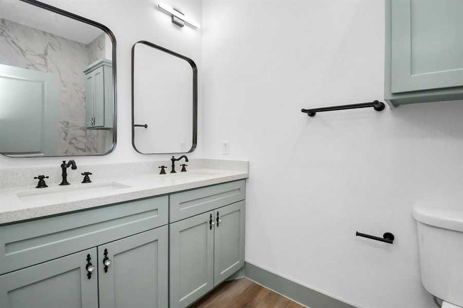 Primary bath with dual sinks and a walk-in shower.