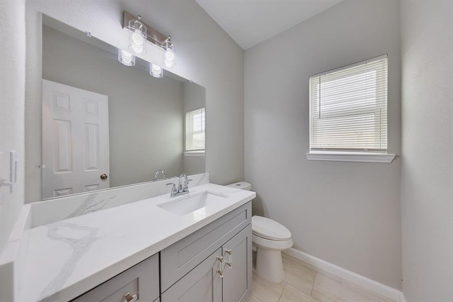 The half bath is a stylish and functional space conveniently located on the main floor. With modern fixtures and elegant finishes, it provides a chic solution for guests and family alike. The thoughtful design ensures that this essential bathroom is both practical and inviting, making it a perfect complement to the home’s overall aesthetic.