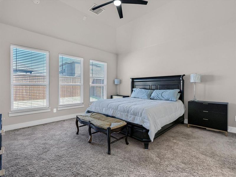 Bedroom featuring a high ceiling, carpet floors, and ceiling fan