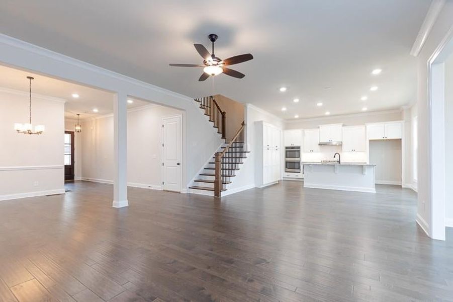 The light-filled family room, accentuated by an optional gas-burning fireplace, offers the perfect setting for cozy nights in or family movie nights. Photo not actual home, but previously built Mansfield plan.