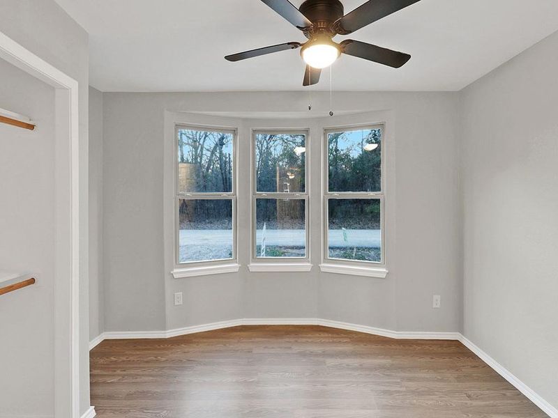 Spare room with light wood-type flooring and ceiling fan