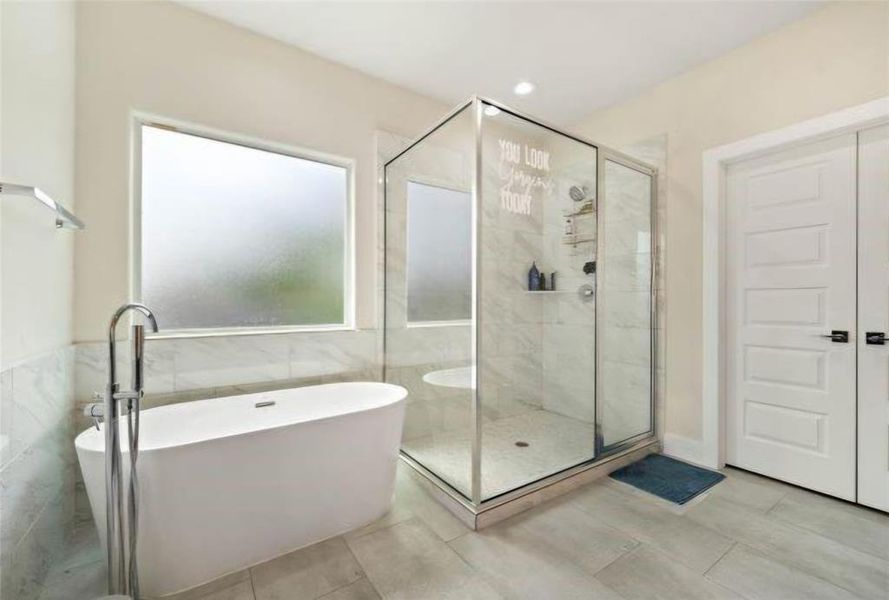 Primary bath with separate soaking tub and extra wide & comfortable shower enclosure