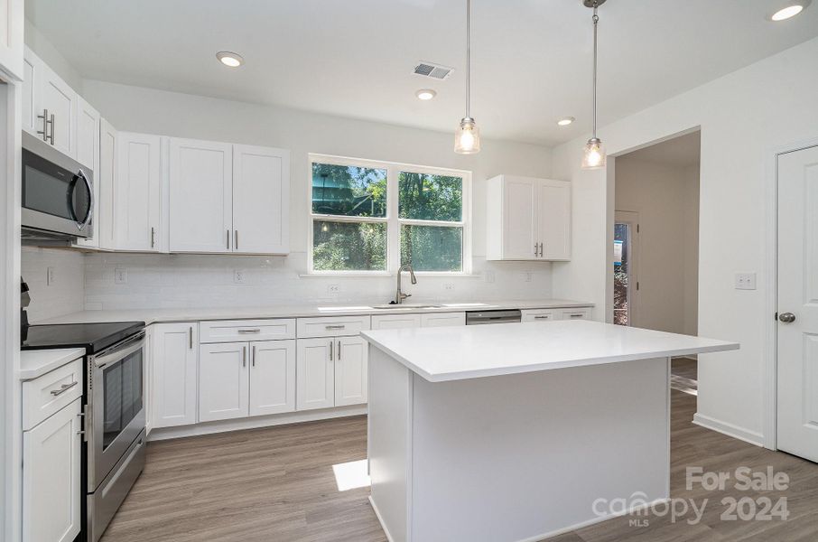 Representative Photo. Large open kitchen with natural lighting