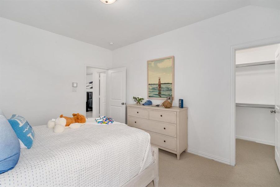 Bedroom with a closet and light colored carpet