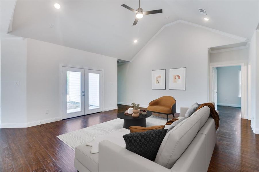 Living room featuring high vaulted ceiling, ceiling fan, french doors, and dark wood-type flooring