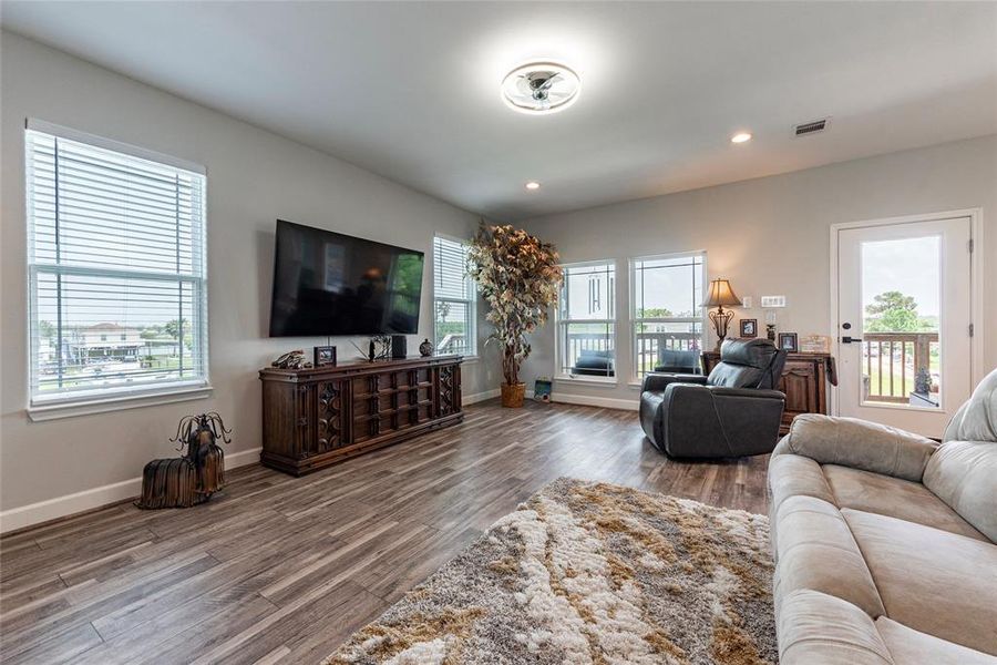 The living room flows effortlessly into the dining and kitchen areas, creating a spacious and cohesive living space.