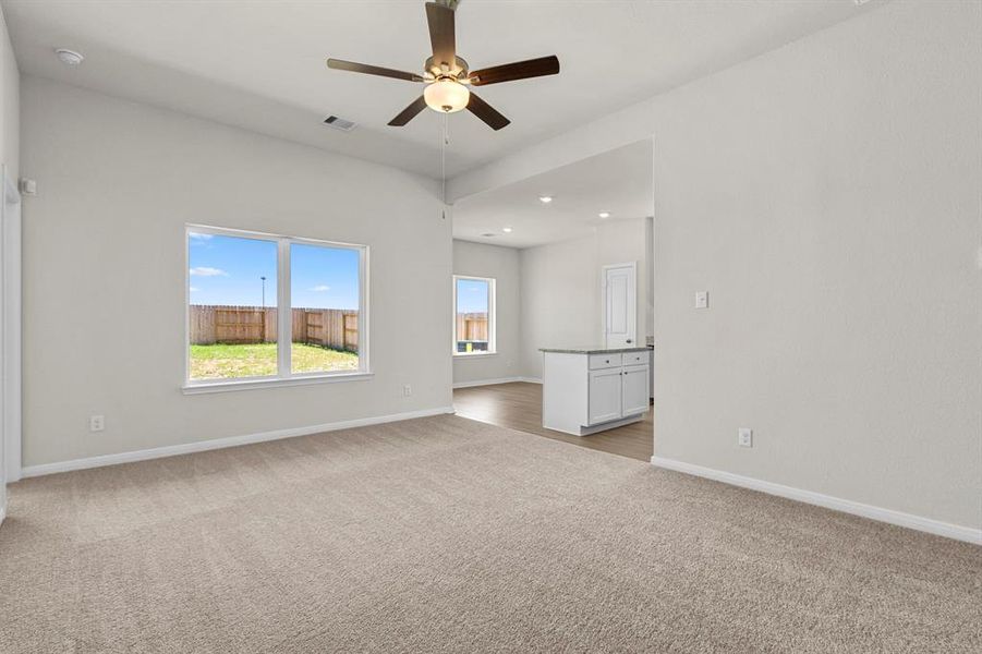 The cozy living area flows into the combined kitchen/dining room.