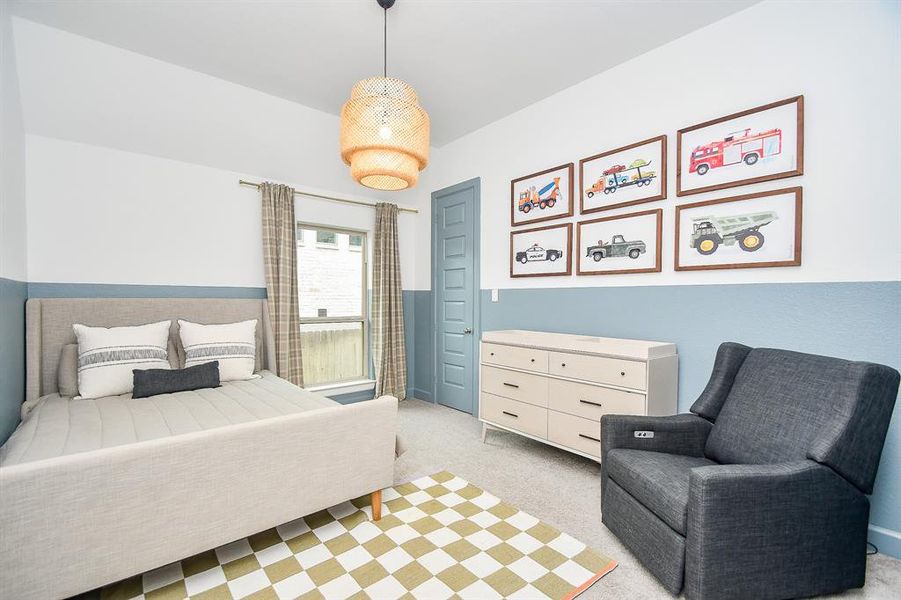 This is a cozy, contemporary bedroom with blue-grey walls and white trim.