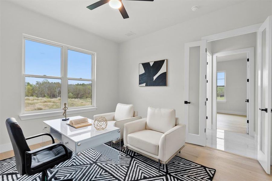 Office featuring ceiling fan and light hardwood / wood-style floors