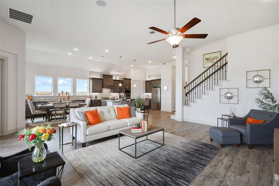 Living room with ceiling fan and wood-type flooring