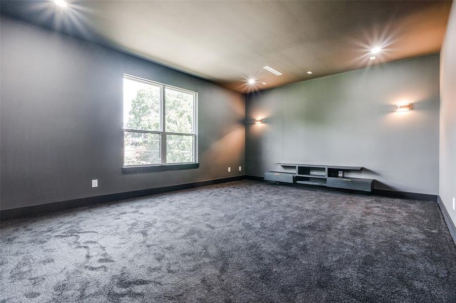 Spare room featuring dark carpet