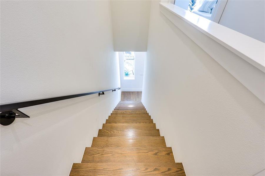 Stairway featuring wood-type flooring