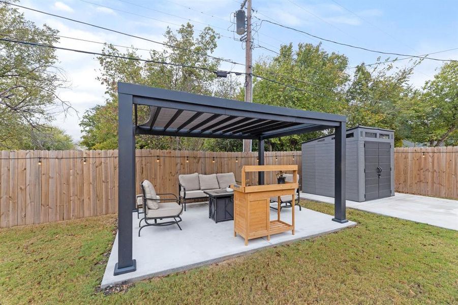 View of patio / terrace featuring an outdoor living space and a storage shed