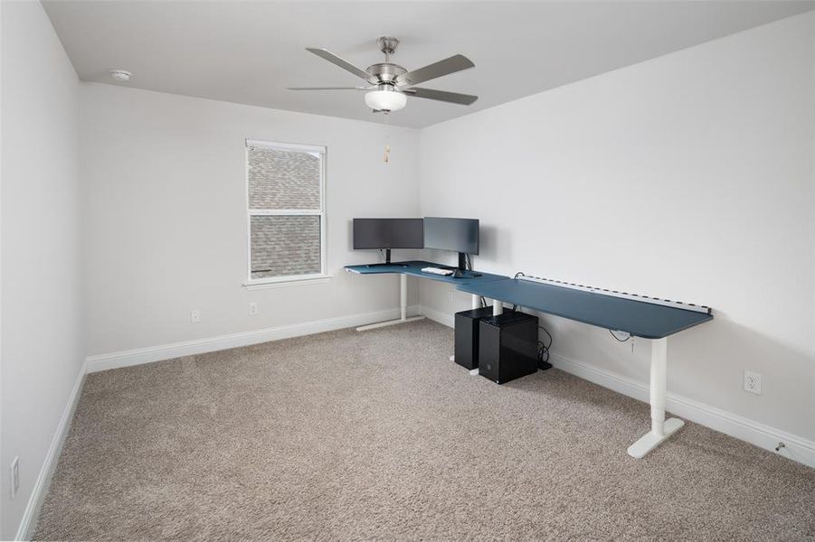 Office featuring light colored carpet and ceiling fan