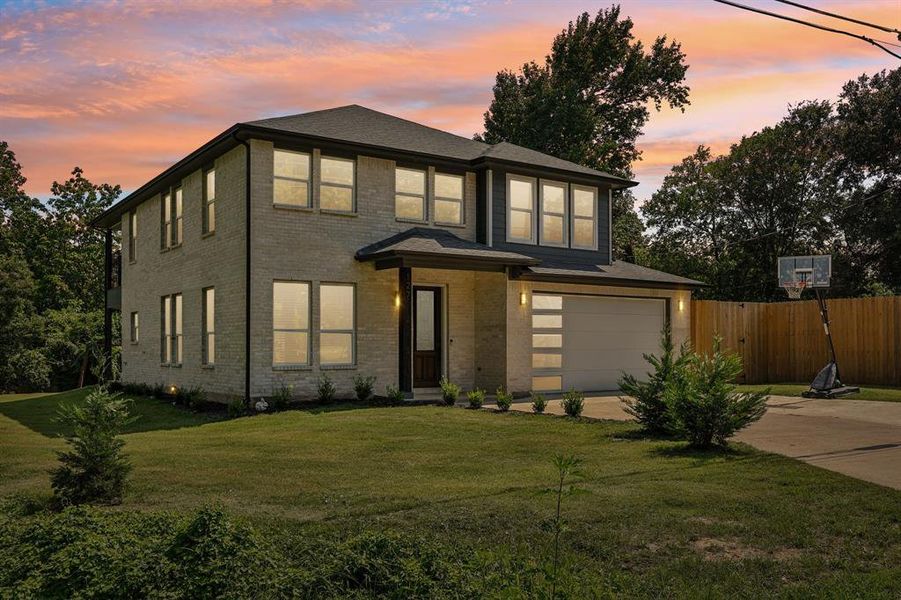 Prairie-style house with a garage and a yard