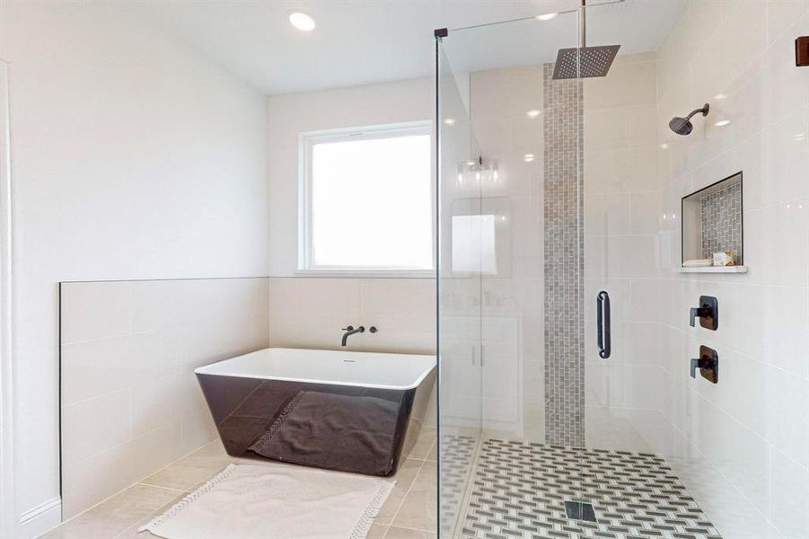 Bathroom featuring tile walls, tile patterned flooring, and independent shower and bath