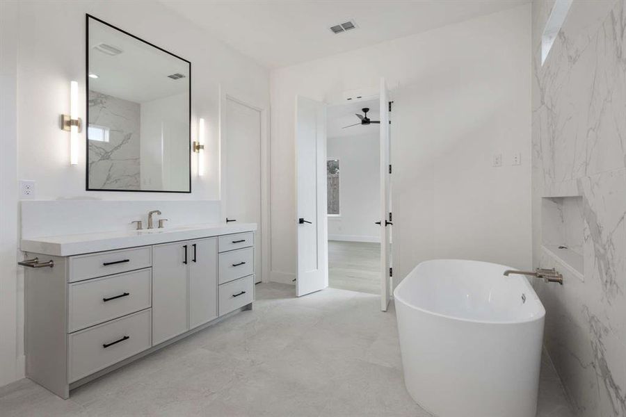 Bathroom featuring a bathing tub, vanity, tile walls, and ceiling fan