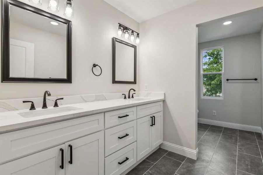 Bathroom featuring vanity and tile patterned floors