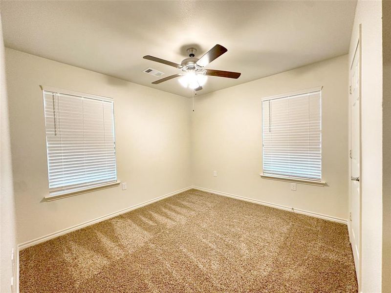 Carpeted spare room with ceiling fan