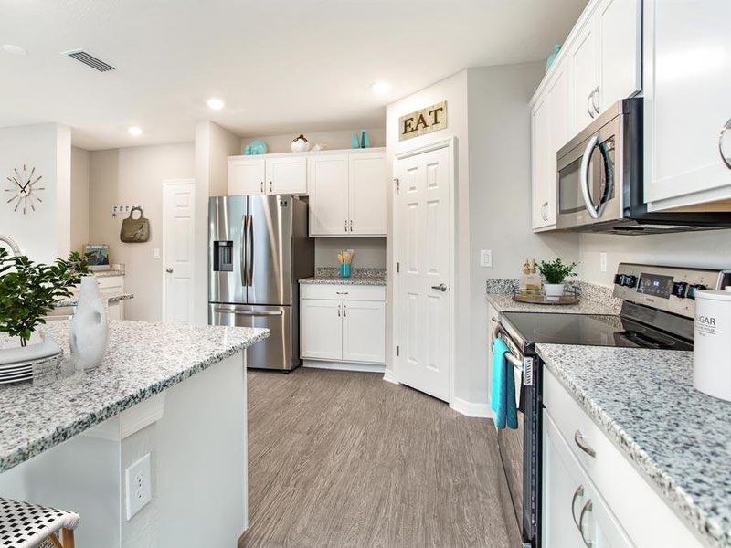 Sunny, open kitchen with walk-in pantry and your choice of finishes - Sydney ll by Highland Homes