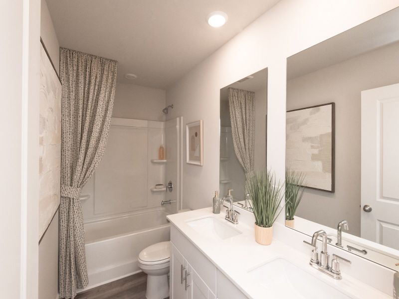 Getting ready in the morning is a breeze in this spacious dual-vanity bathroom.
