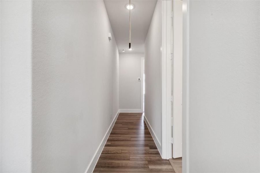 Corridor with dark hardwood / wood-style floors