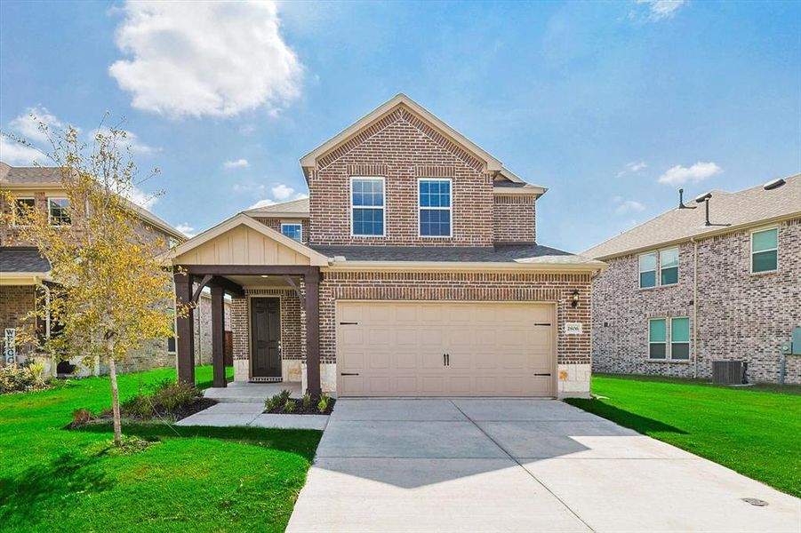 Craftsman inspired home featuring a front yard, central AC unit, and a garage