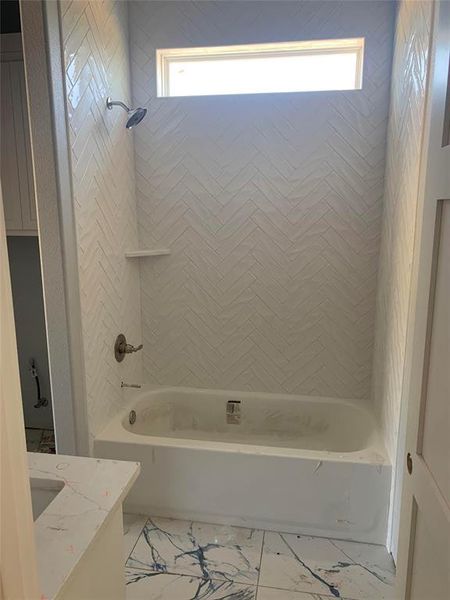 Bathroom with vanity and tiled shower / bath combo