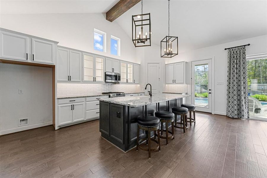 A spacious island that's perfect for cooking and entertaining, this kitchen also boasts customized cabinets and tons of natural lighting.