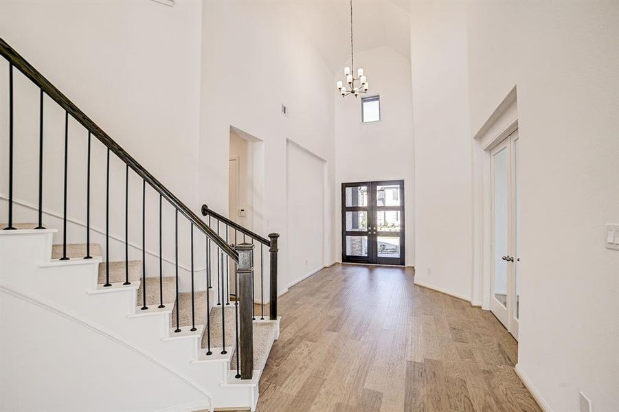 Upgraded wood flooring throughout the entire first floor, French glass doors to your right lead to the office, hallway to the left leads to garage and utility.