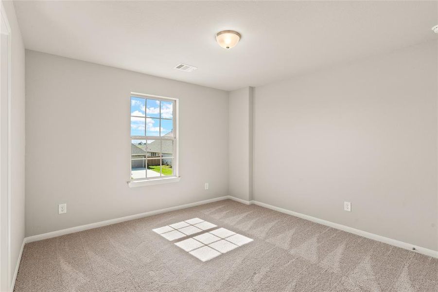 Your secondary bedroom features plush carpet, fresh paint, closet, and a large window that lets in plenty of natural lighting.