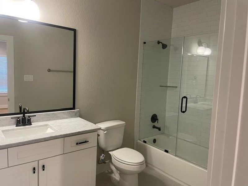 Secondary bathroom with glass shower doorsLivi