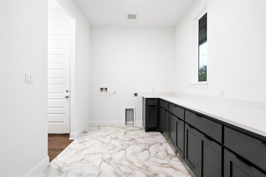 Oversized laundry/utility room that connects to the garage and primary bedroom