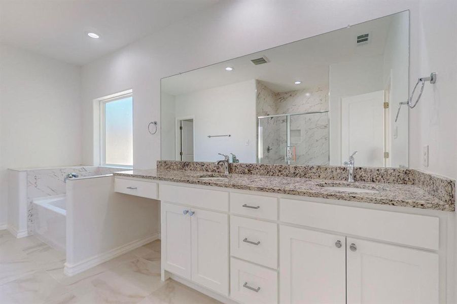 Another angle of Primary Bathroom featuring vanity and separate shower and tub