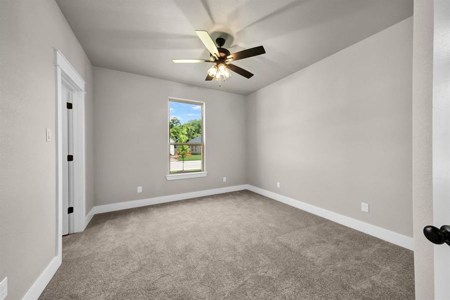Unfurnished room featuring carpet and ceiling fan