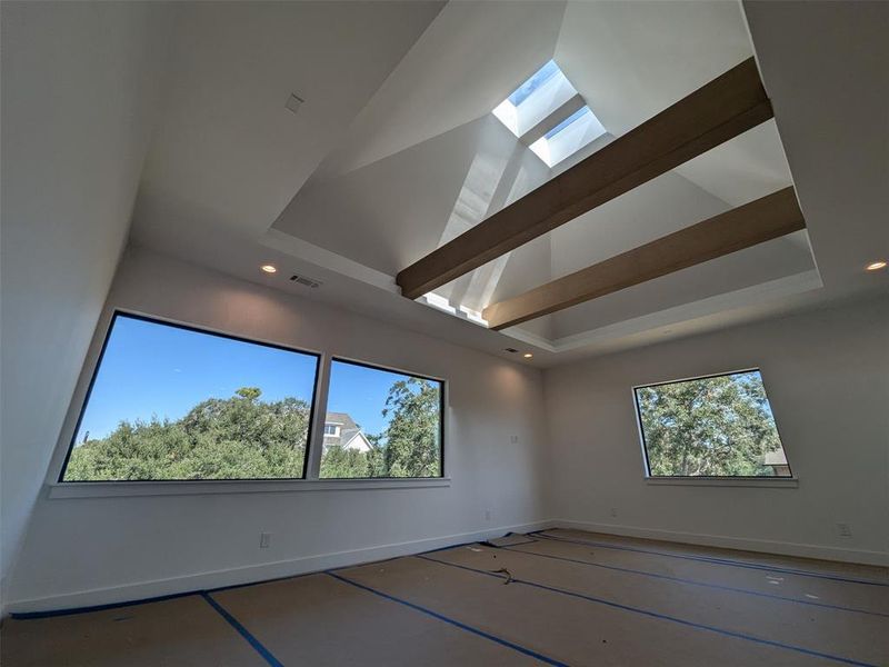 Large windows with views of mature tree canopy creates an inviting natural tableau.