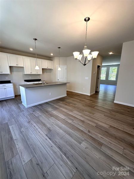 GOURMET KITCHEN FEATURES WHITE KITCHEN CABINETS AND QUARTZ COUNTERTOP.