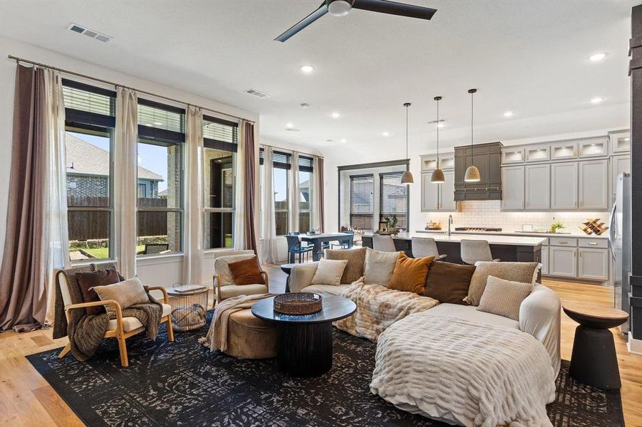 Living room featuring ceiling fan and light hardwood / wood-style flooring