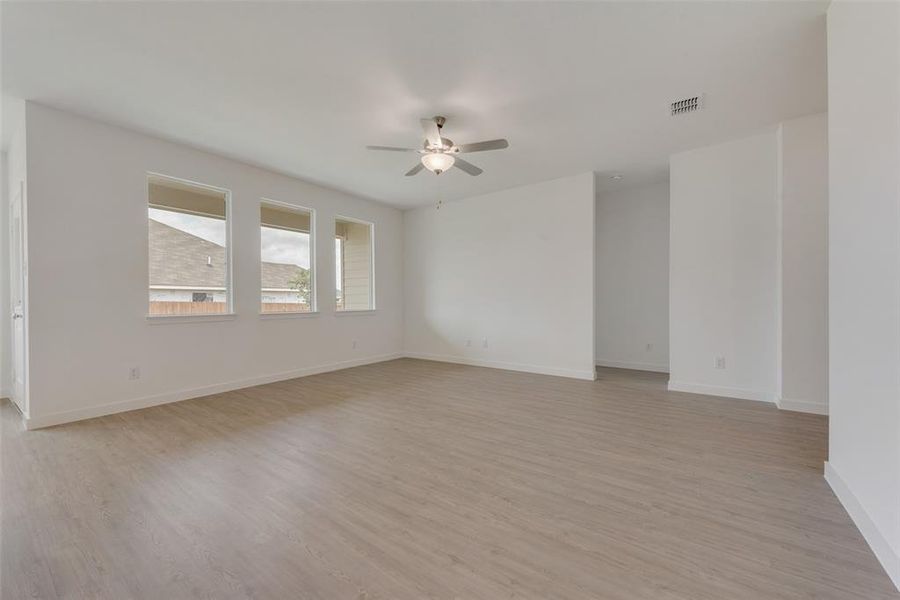 Spare room featuring ceiling fan and light hardwood / wood-style floors