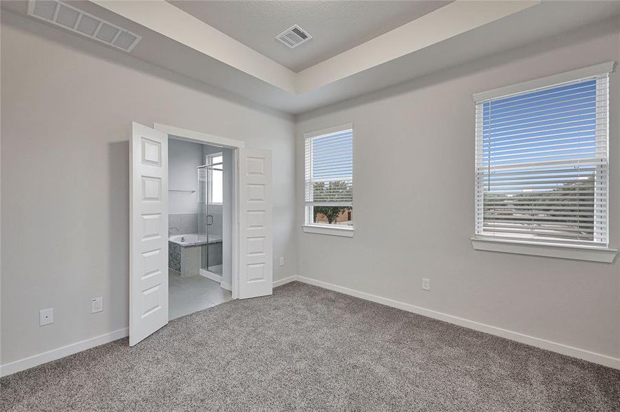 Primary bedroom with double door entry to bath.