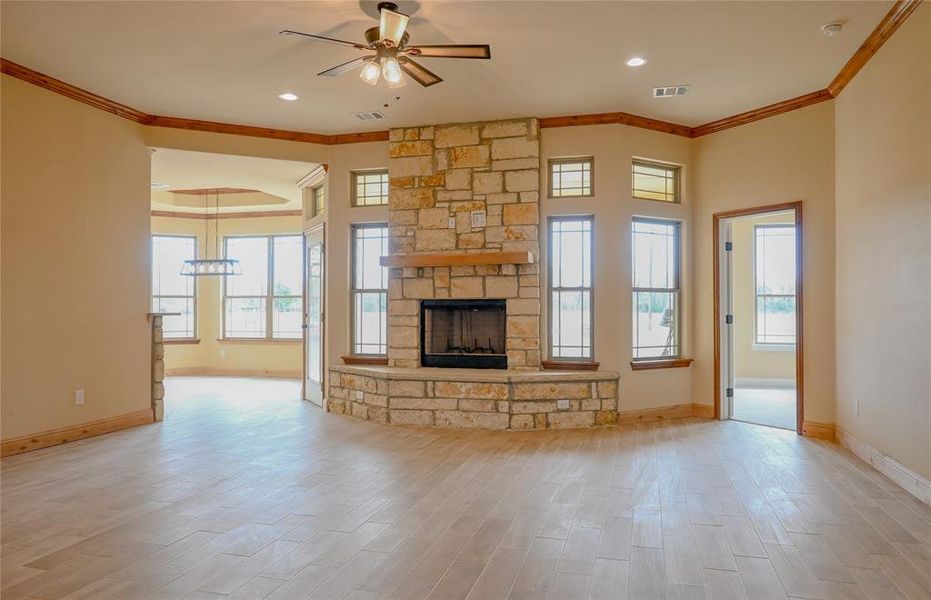 Step inside this gorgeous home and notice the attention to detail.  Crown molding, floor to ceiling stone fireplace, Smurf tube for electronics, and tons of windows.