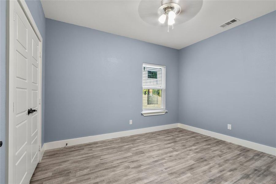 Unfurnished bedroom with light hardwood / wood-style floors and ceiling fan