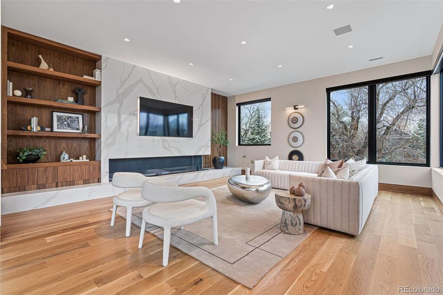 Versatile upper-level retreat with an expanse of windows, Ecosmart fireplace and built-ins.