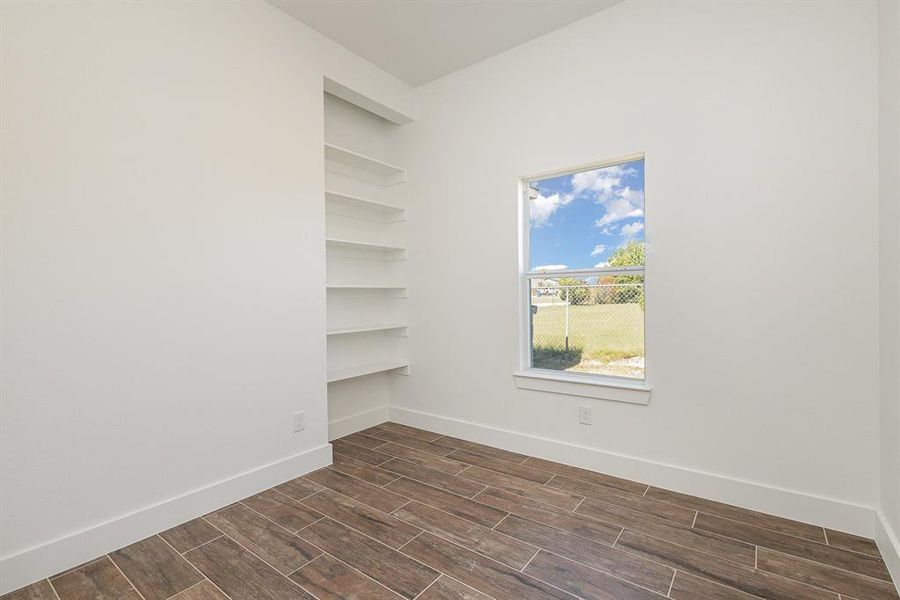 Empty room with dark wood-type flooring