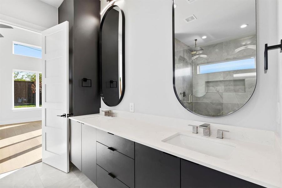 Bathroom with vanity, tile patterned floors, and walk in shower