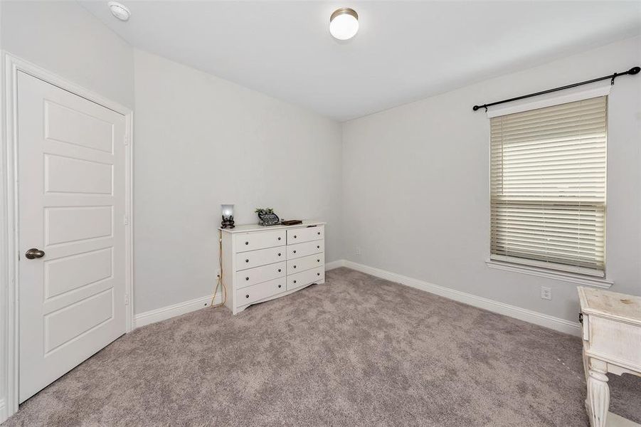 Unfurnished bedroom featuring light colored carpet