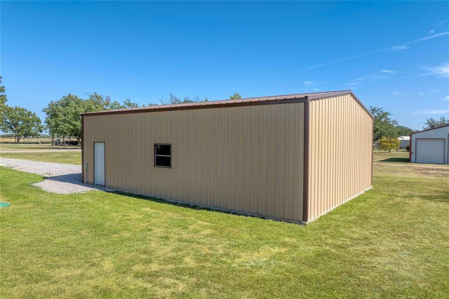 View of outdoor structure with a yard